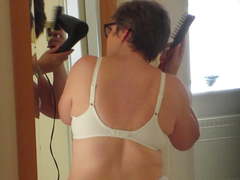 Wife hangs belly and breasts, dries hair in lingerie